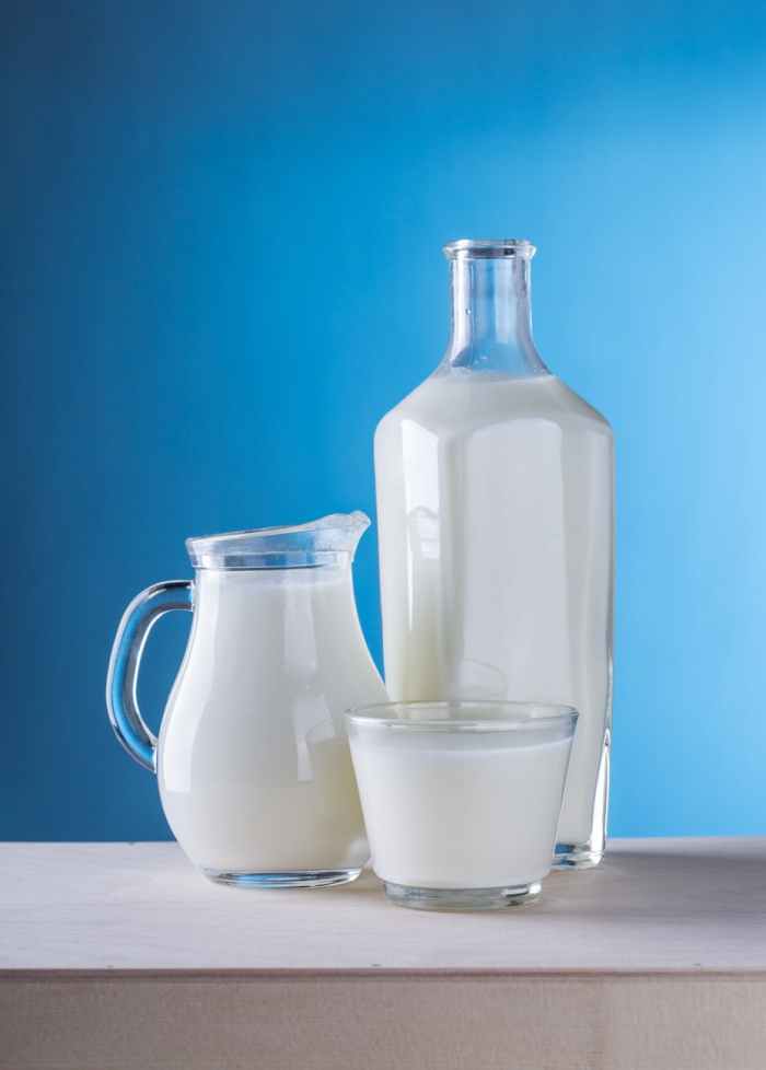 close up of milk against blue background